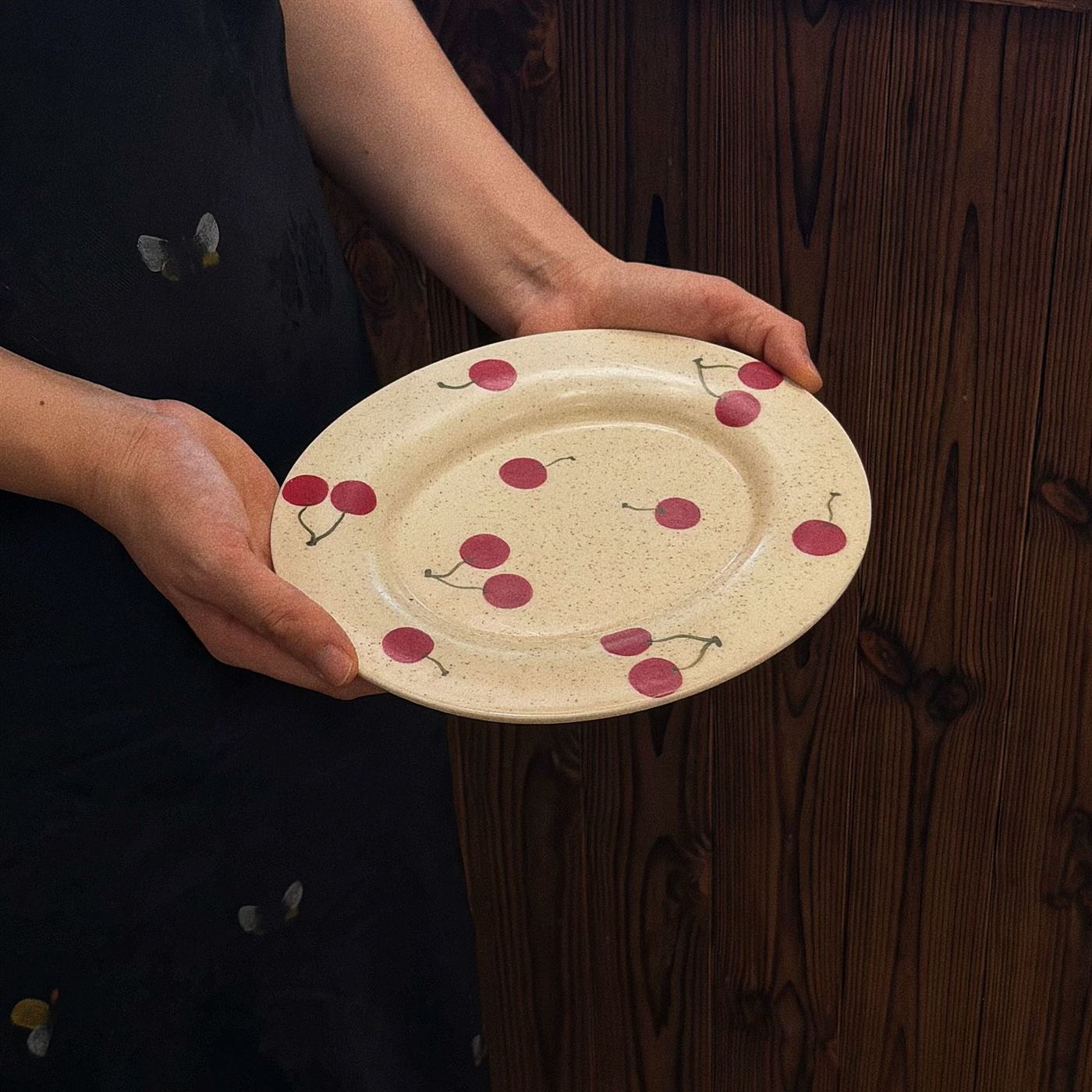 Vintage cherry ceramic fruit plate shown in hand