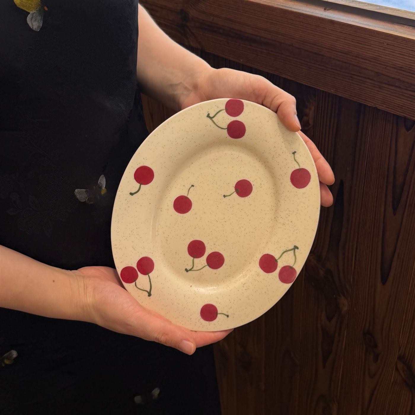 Close view of the hand painted cherry plate pattern