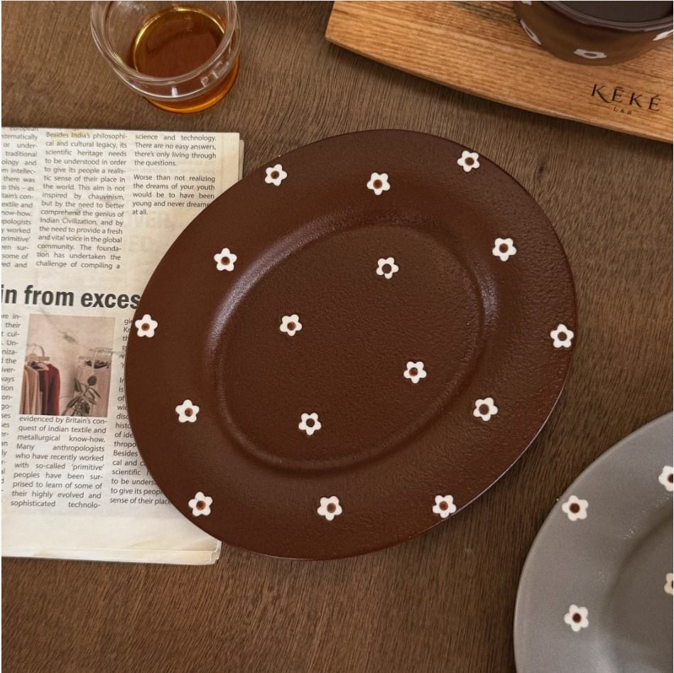 Brown oval ceramic cake plate with small white flowers
