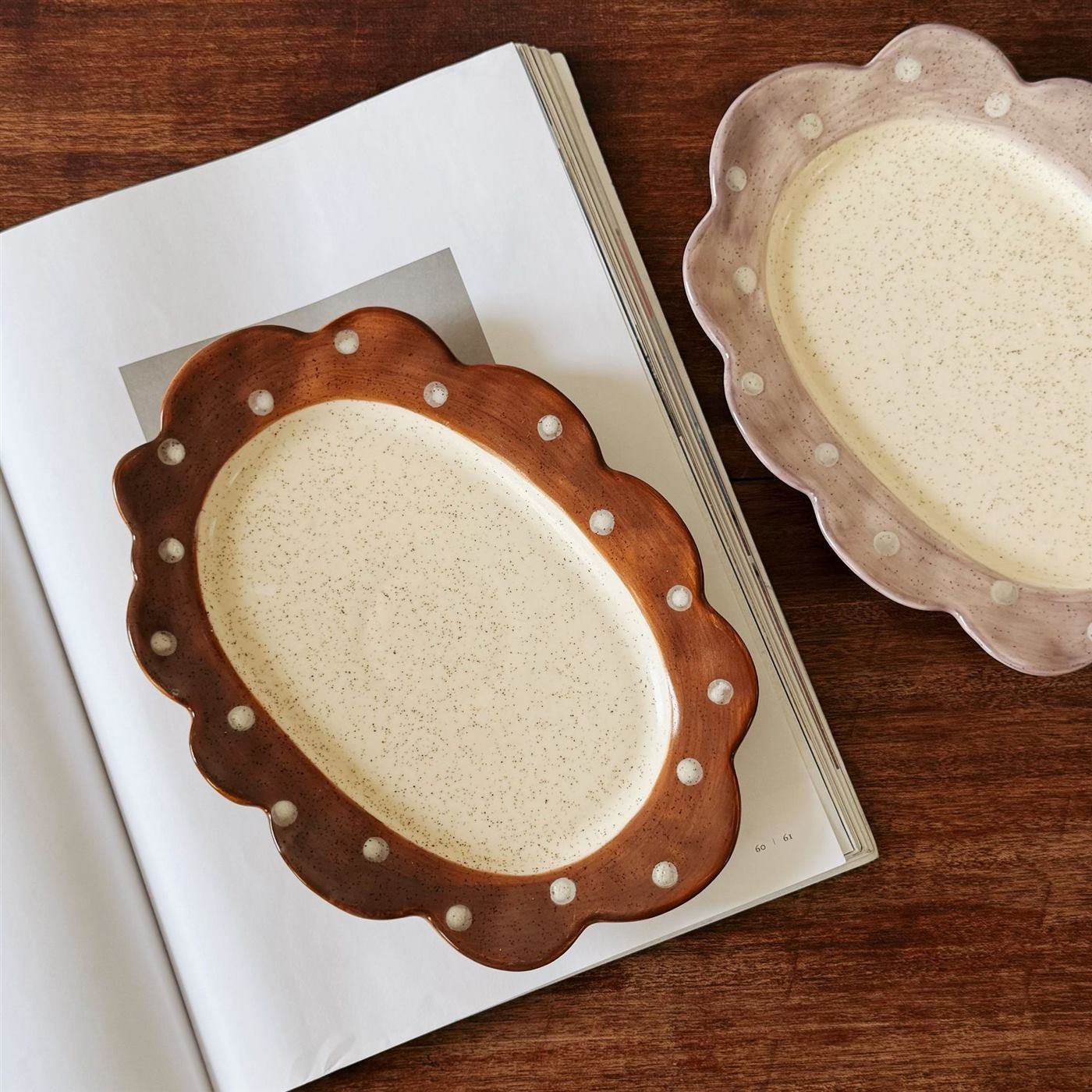 Brown and purple ceramic plates with hand-painted polka dots