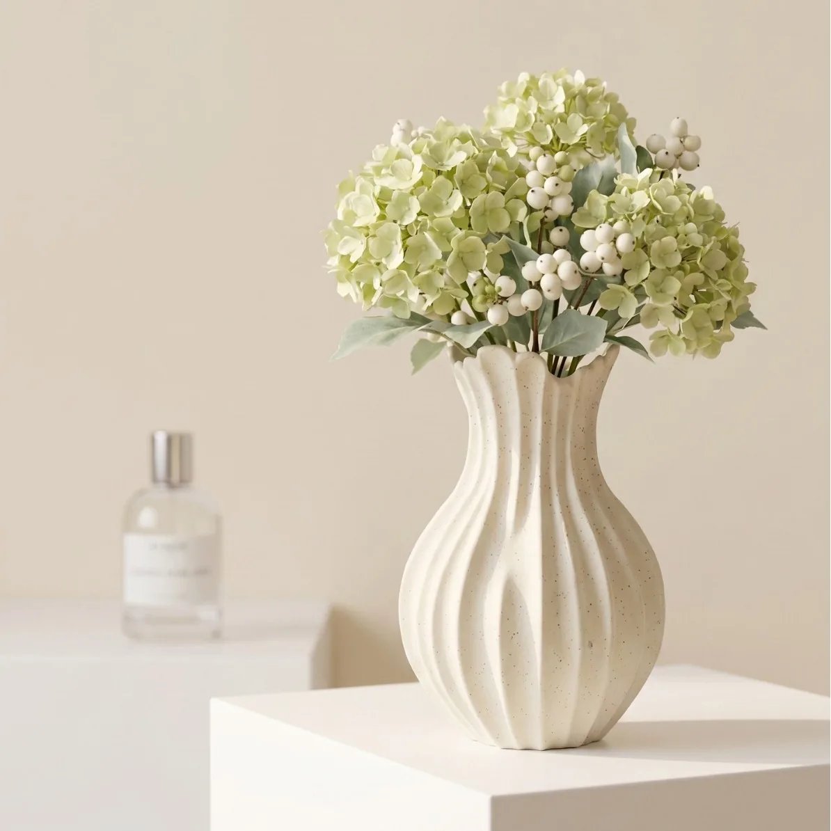 Ivory speckled ribbed ceramic vase with hydrangeas