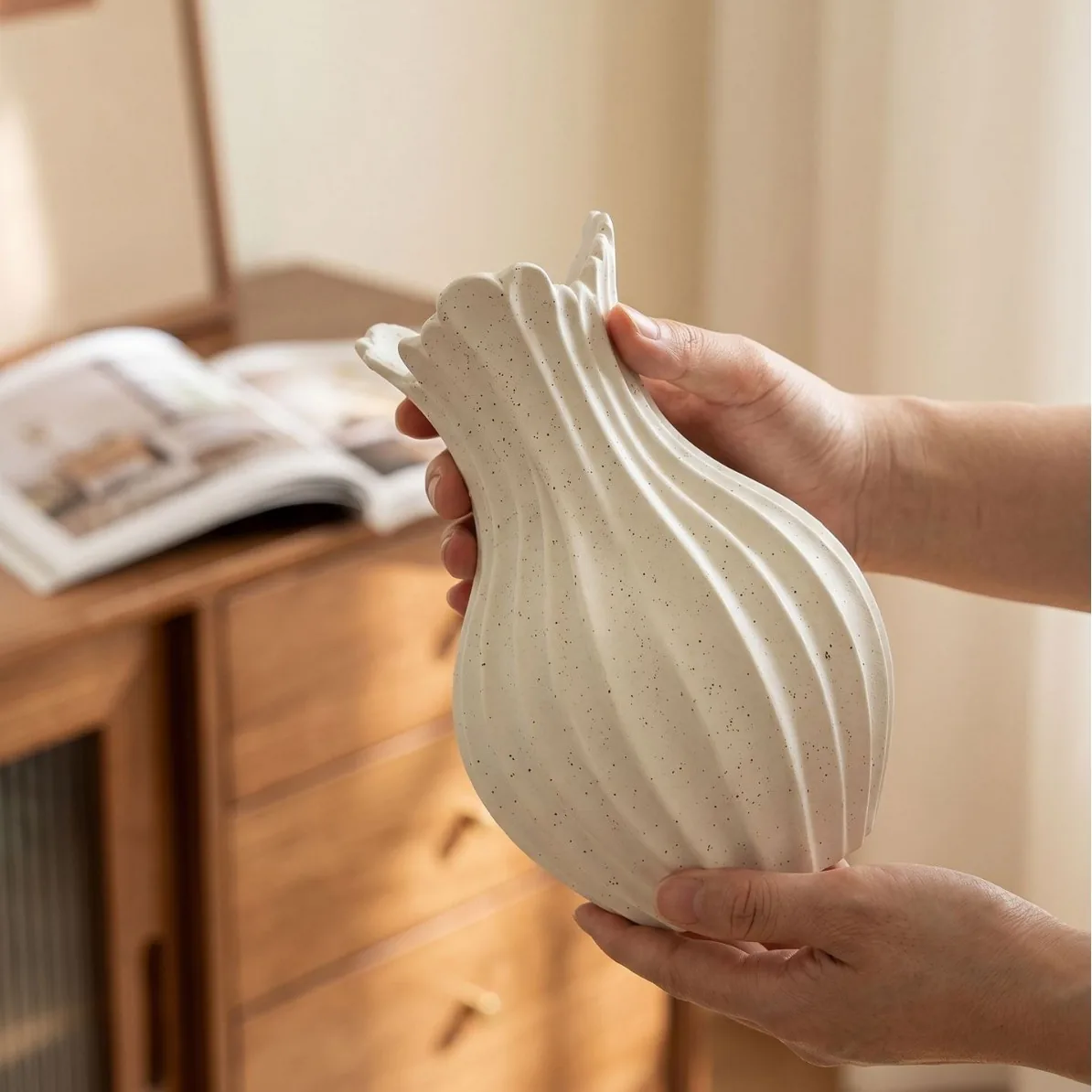 Close-up of ivory speckled ceramic vase texture